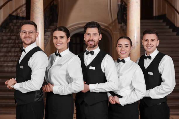 Group of trainees wearing formal clothes in hotel. Professional butler courses